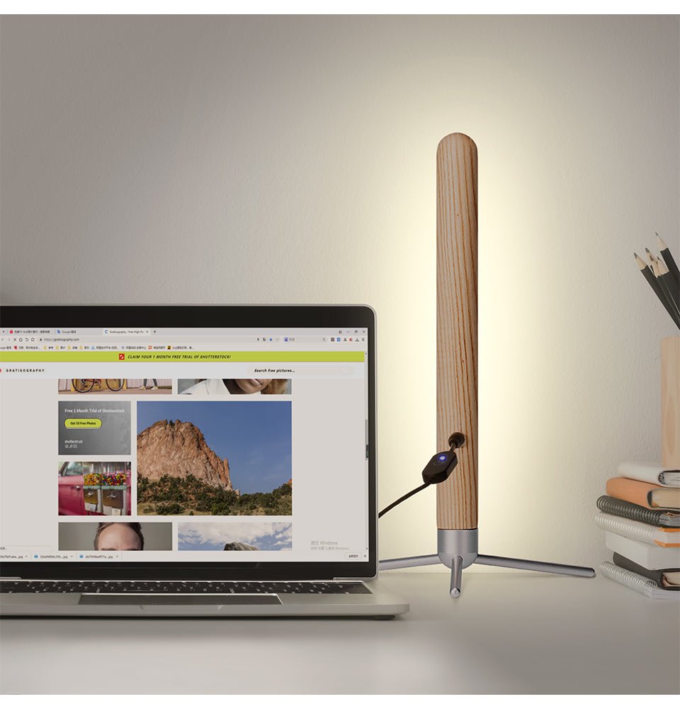 Vertical wood eye-protection desk lamp with magnetic wooden LED illuminator and sturdy metallic base.
