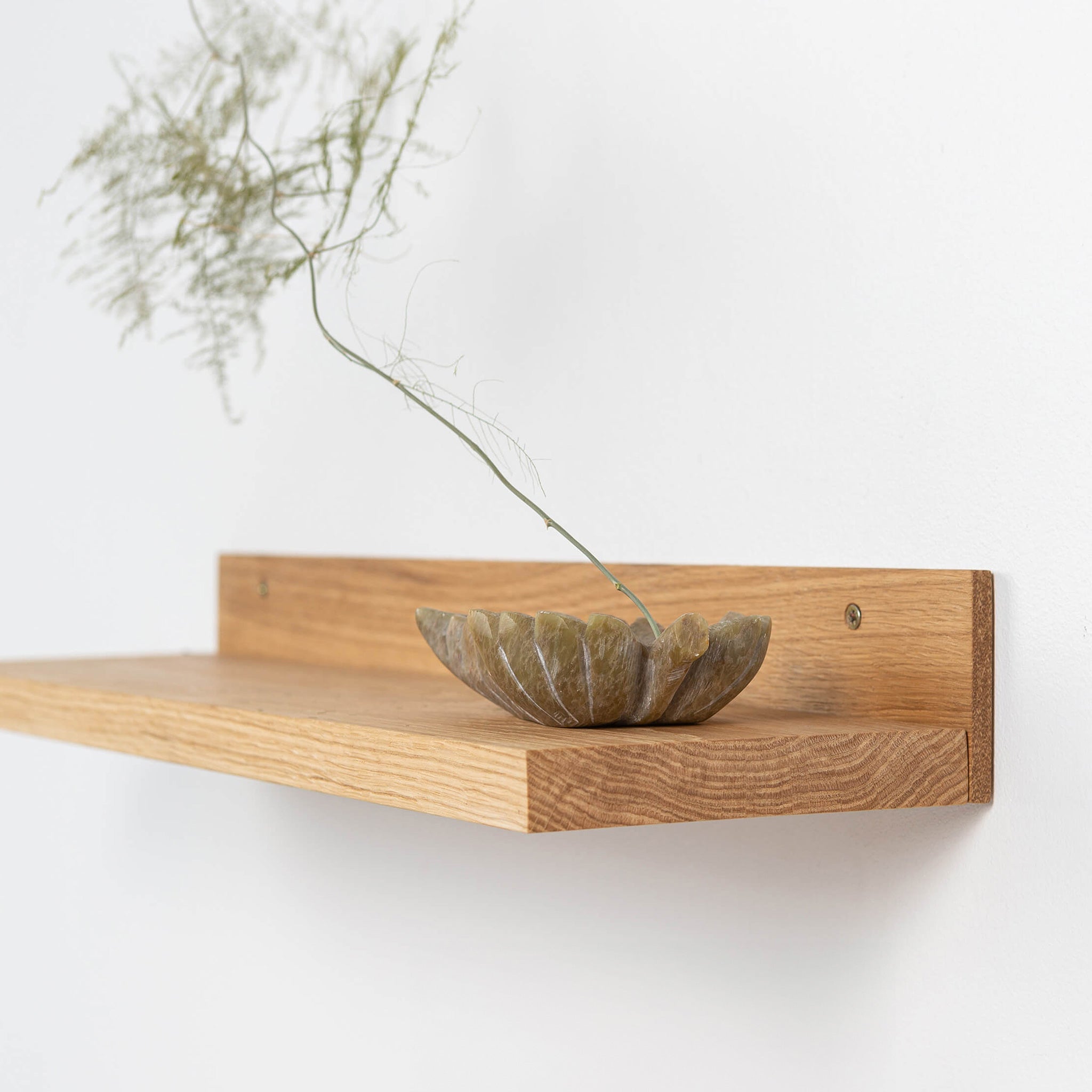 Two natural solid oak wood floating shelves mounted on a minimalist living room wall — view 3