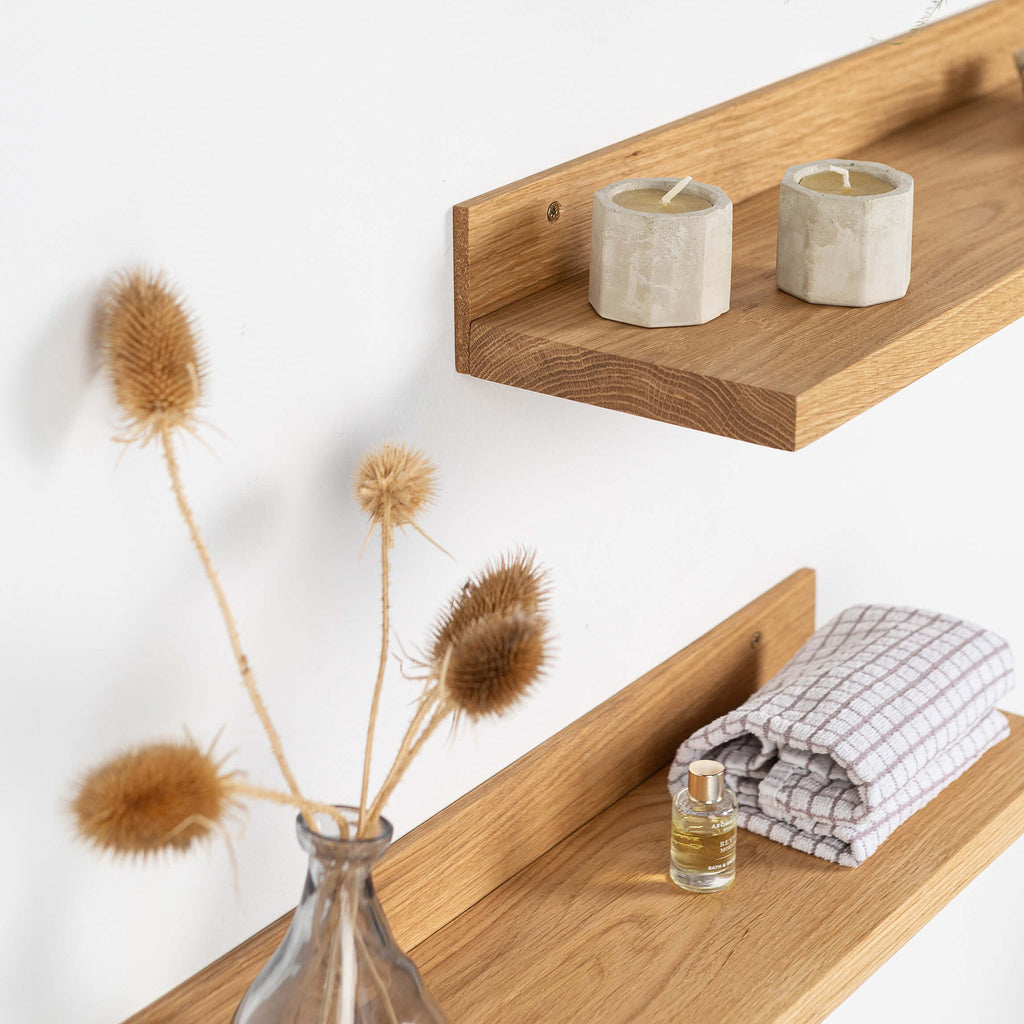 Two natural solid oak wood floating shelves mounted on a minimalist living room wall — view 2