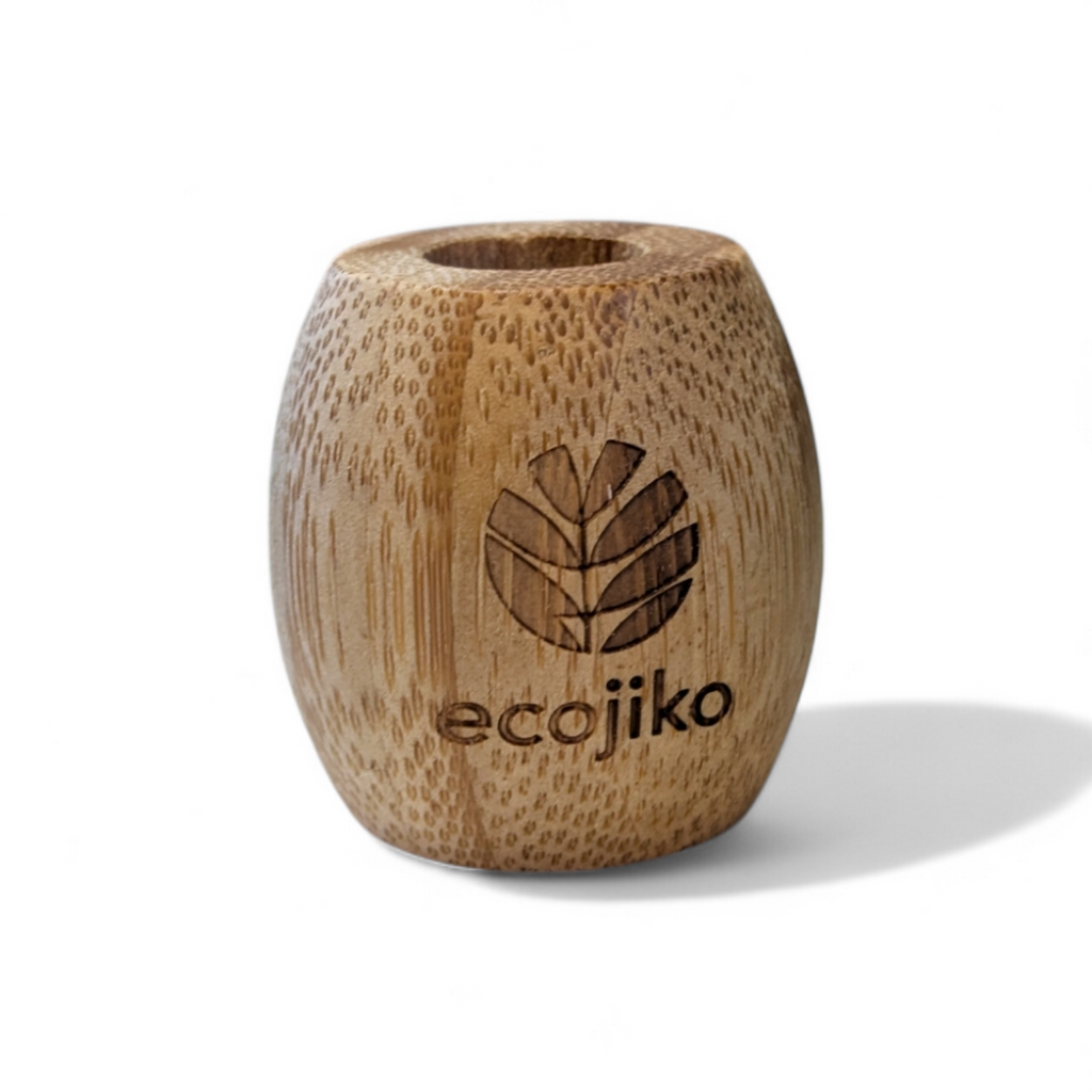 Unwaxed bamboo toothbrush stand on a bathroom counter holding a wooden adult toothbrush — view 5