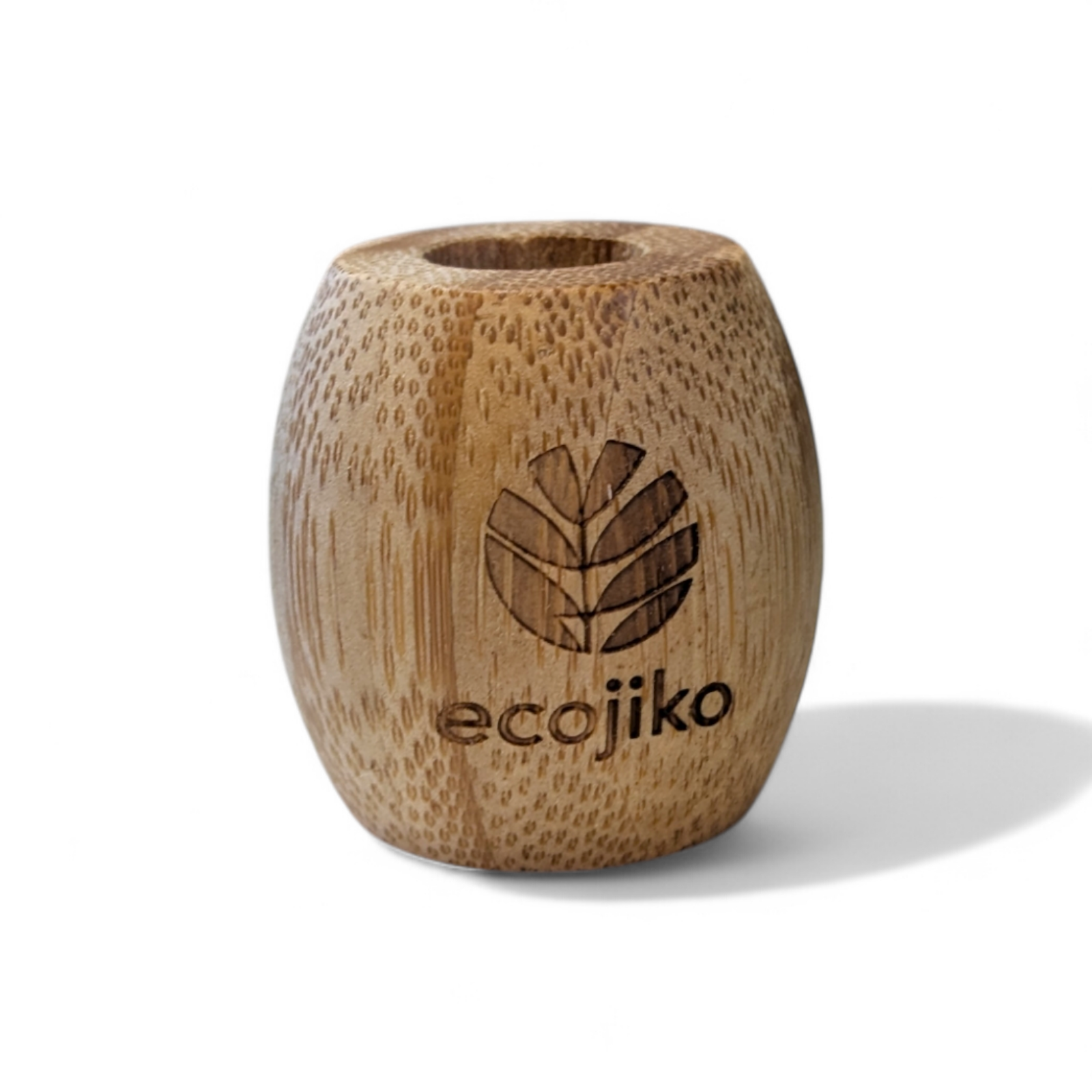 Unwaxed bamboo toothbrush stand on a bathroom counter holding a wooden adult toothbrush — view 5