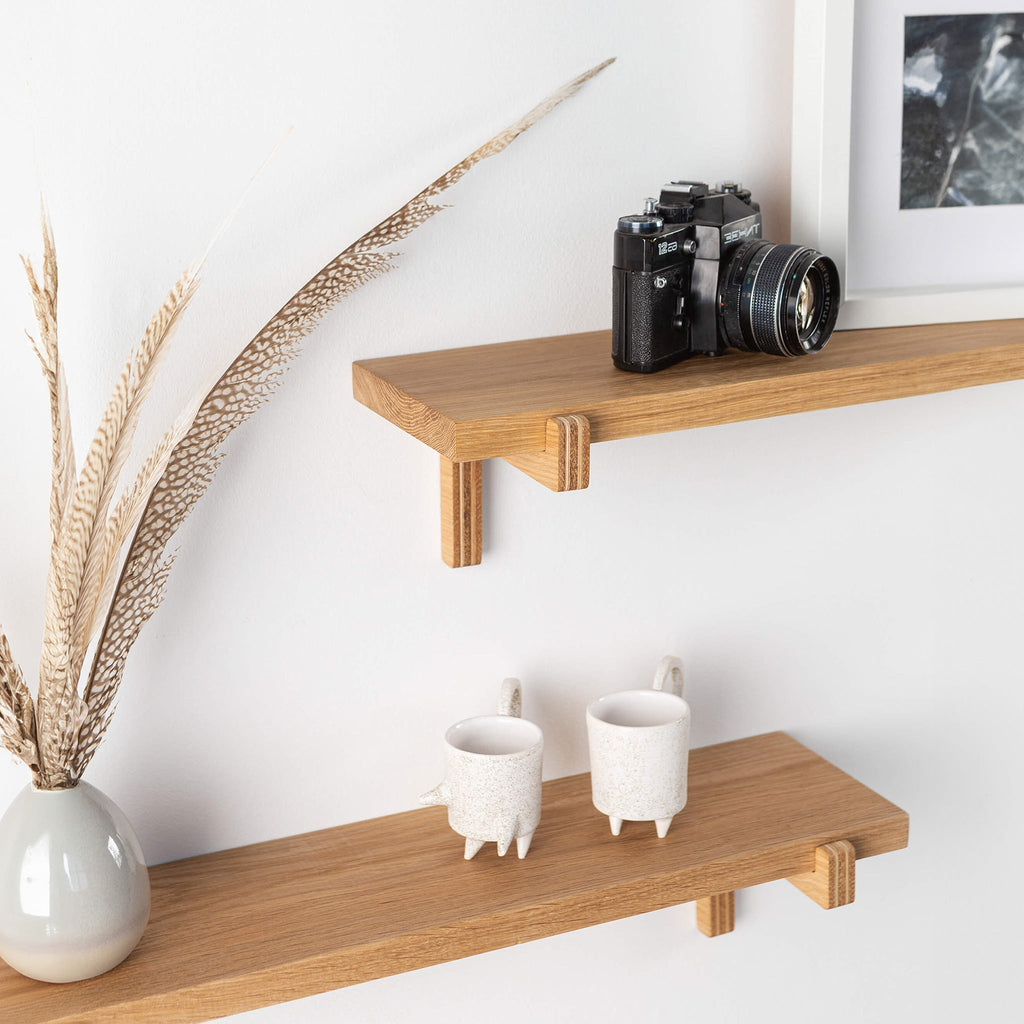 Two natural oak wood floating wall shelves with minimal home decor items and plants — view 2