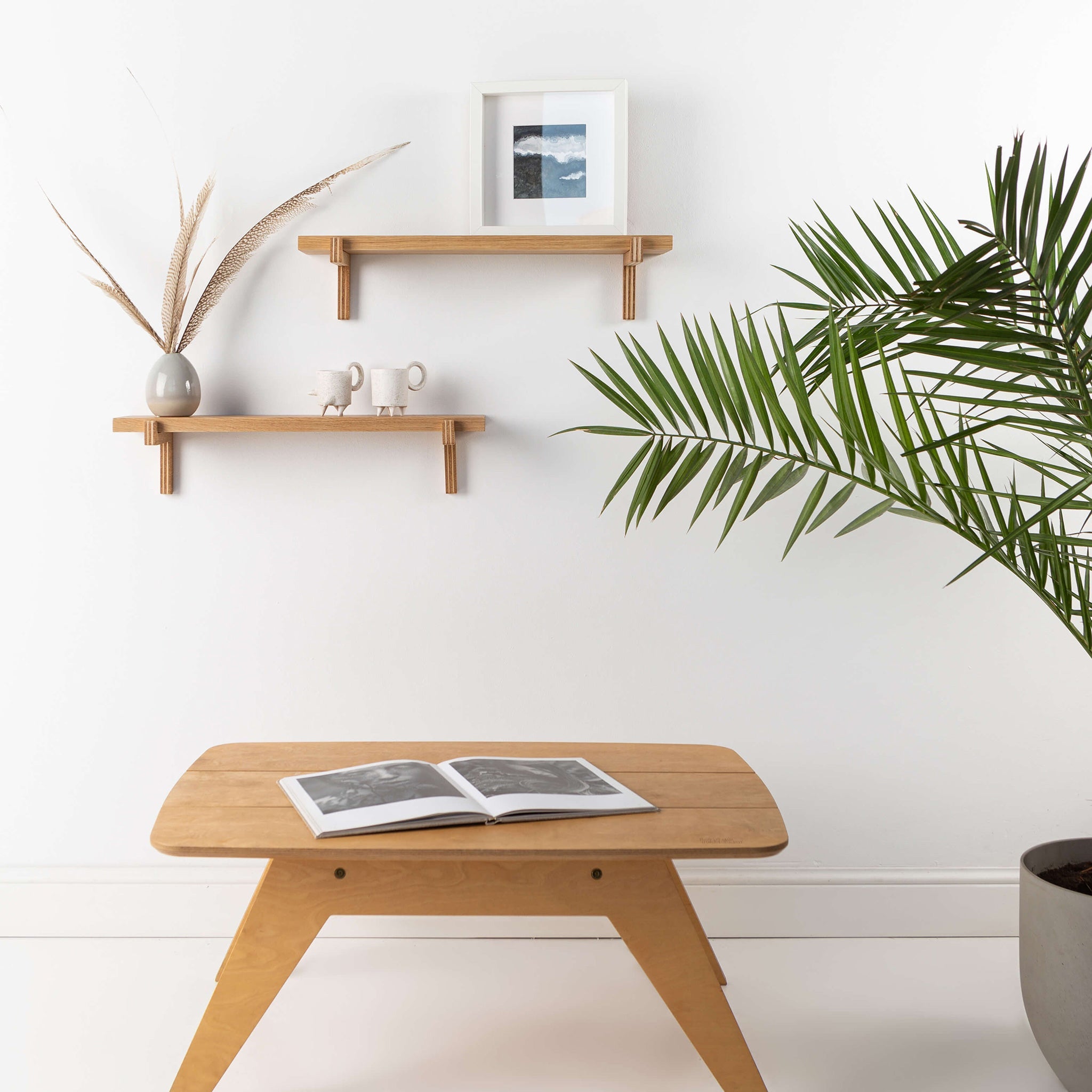 Two natural oak wood floating wall shelves with minimal home decor items and plants — view 3