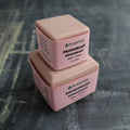 Square solid zero waste rose and citrus deodorant bar displaying natural botanical ingredients